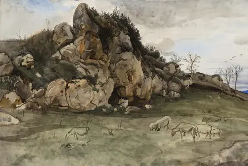 Das Bild einer Felsformation, im Vordergrund grasen Schafe.