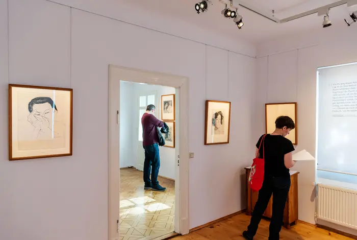 Menschen in einem lichtdurchfluteten Ausstellungsraum.